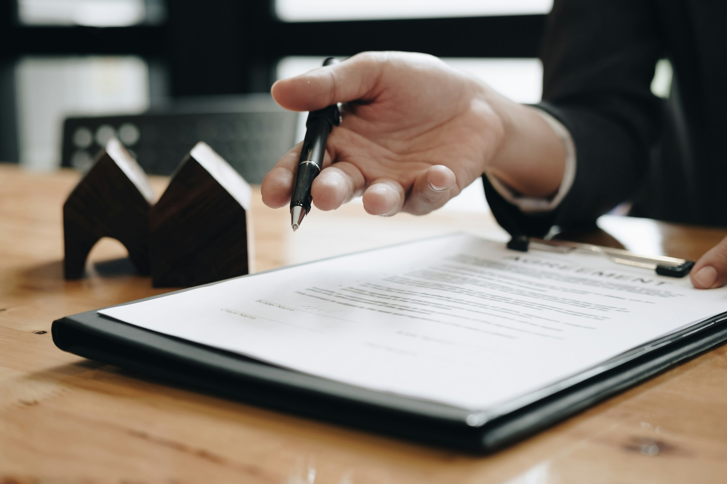Person reviewing mortgage penalty and IRD documents at a desk