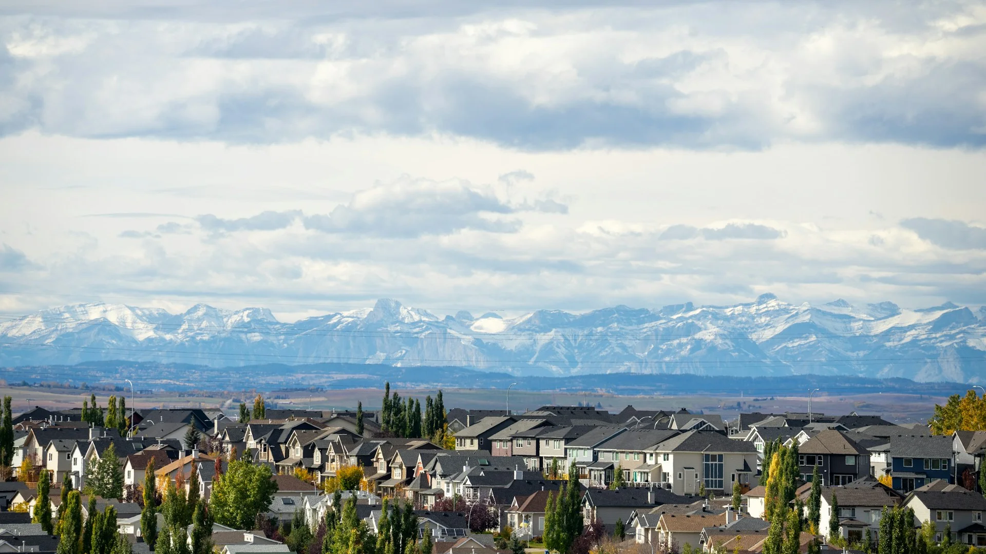 Calgary residential neighbourhood with the Rockies visible on the horizon