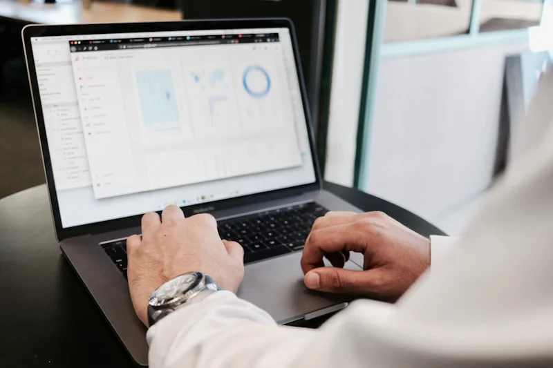 Person reviewing website analytics and financial partnership documents on a laptop