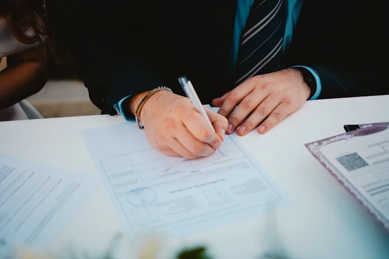 Person reviewing mortgage paperwork and rate documents at a desk